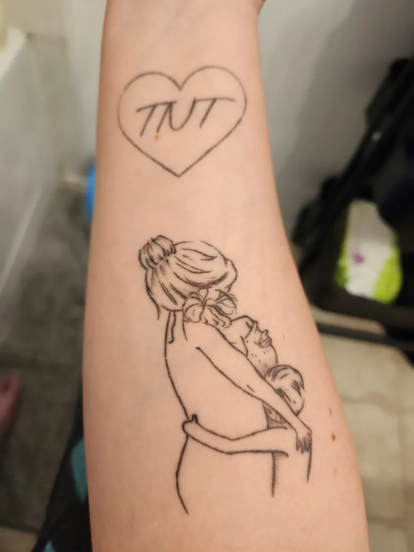 Fine-line mother and child tattoo with a heart on a forearm